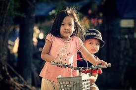 Two young kids on bikes