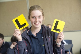 Female student holding L plates