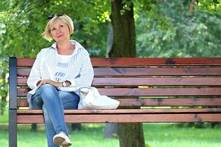 Woman sitting on bench thinking