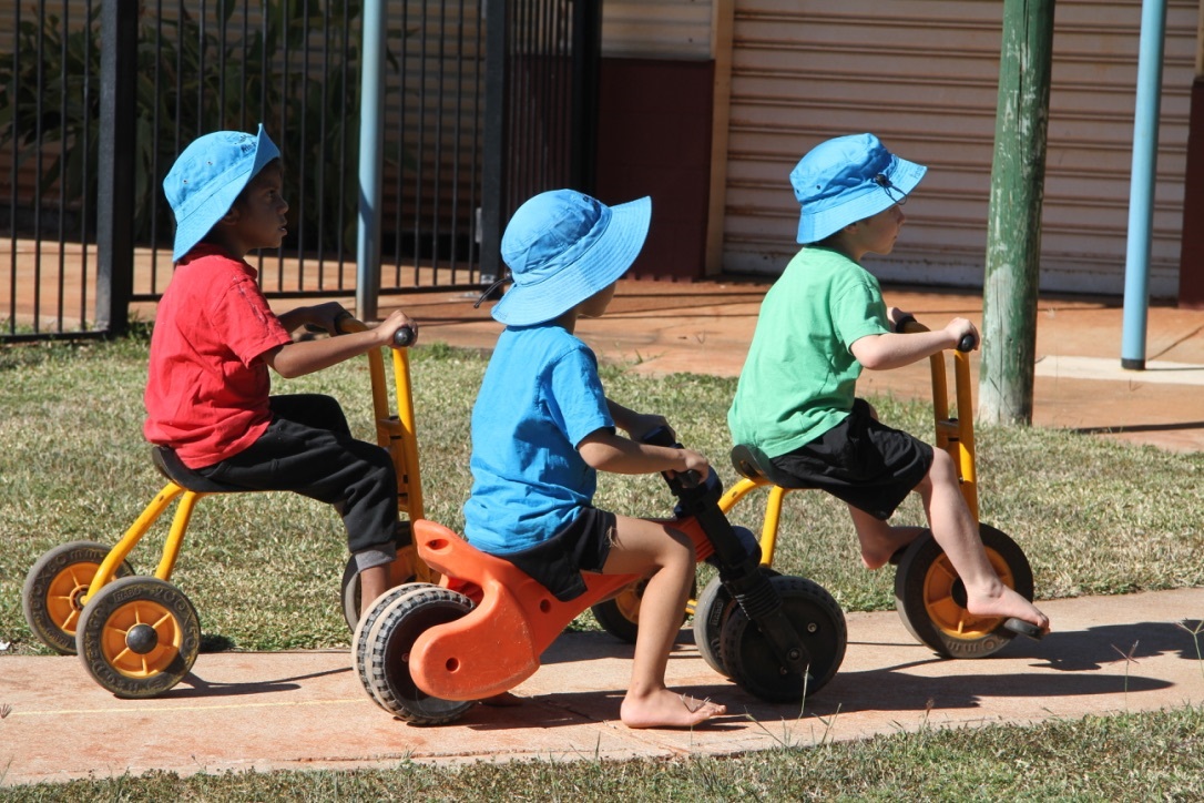 3 little kids on trikes